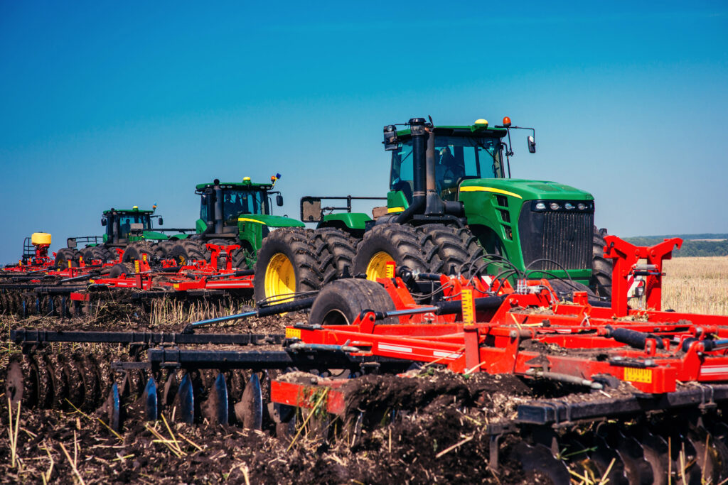 Tractor plowing farm field in preparation for spring planting.